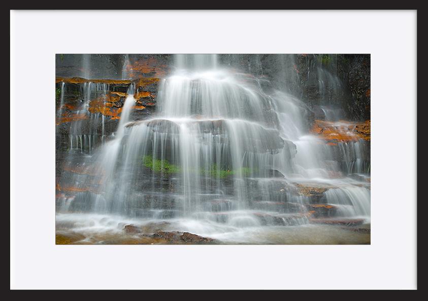 65997376 Waterfall coming down on the cliffs copy - ArtFramed