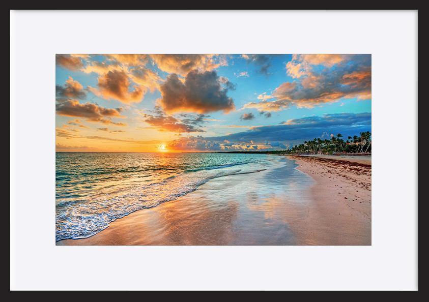 87306701 Bright and dynamic sea beach sunrise with bright blue skies and colorful clouds copy - ArtFramed