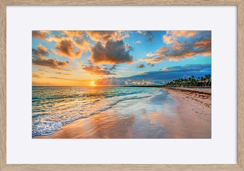 87306701 Bright and dynamic sea beach sunrise with bright blue skies and colorful clouds copy - ArtFramed