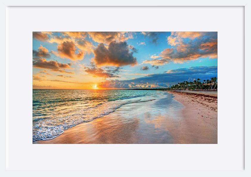 87306701 Bright and dynamic sea beach sunrise with bright blue skies and colorful clouds copy - ArtFramed
